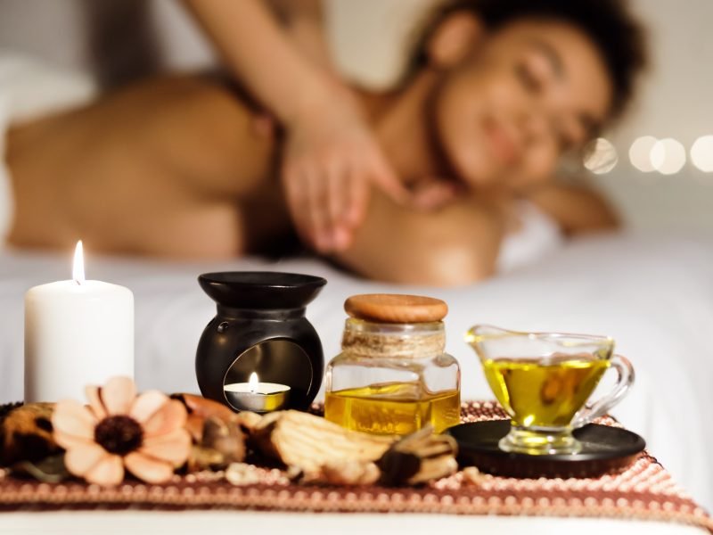 Aroma massage. Relaxed lady enjoying back massage