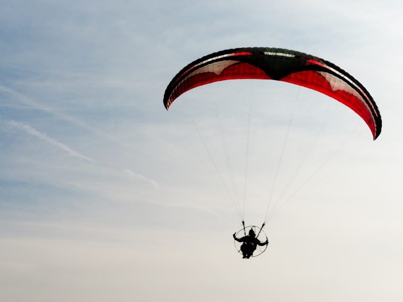 One Man Rides Flies Ultralight Flying Through Blue Sky