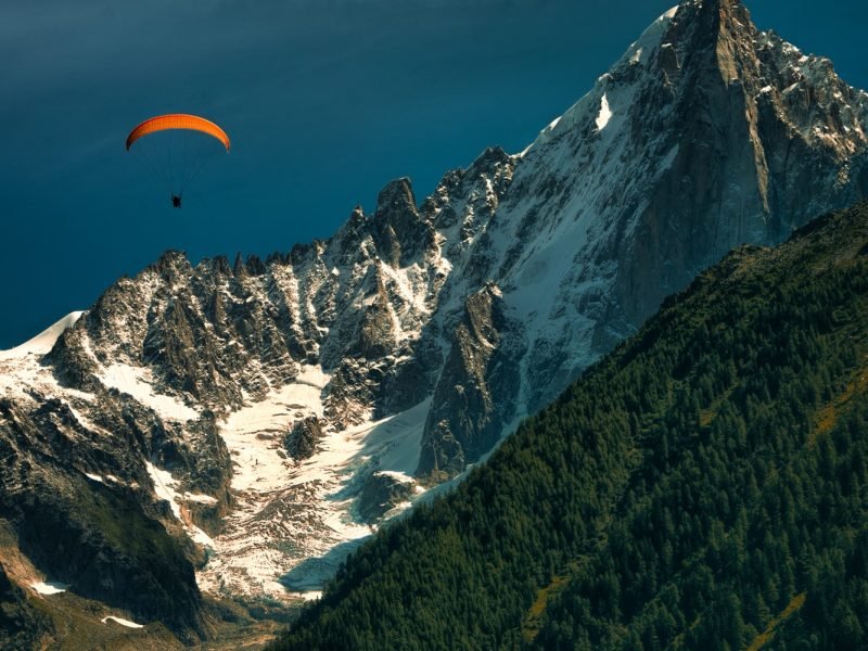 Orange paragliding in the mountains